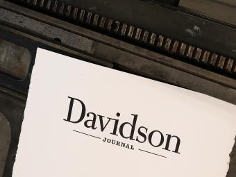 Paper with the " Journal" wordmark printed on it atop a letterpress